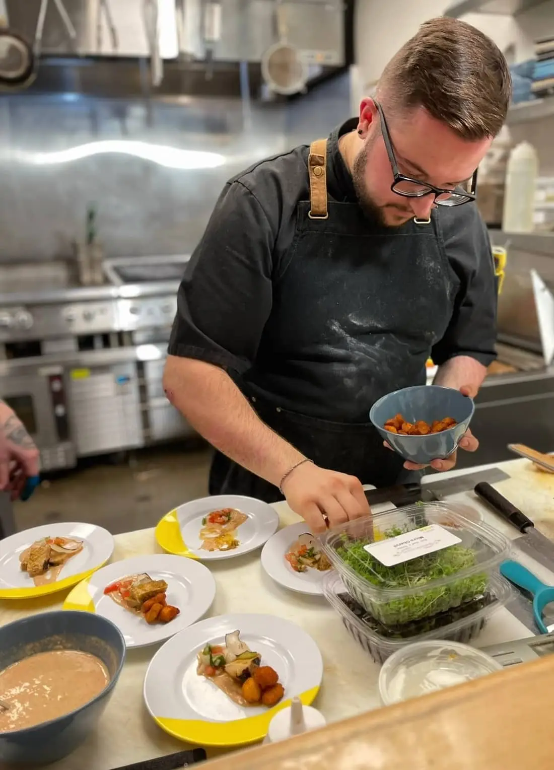 Chef Josh plating a course in the kitchen