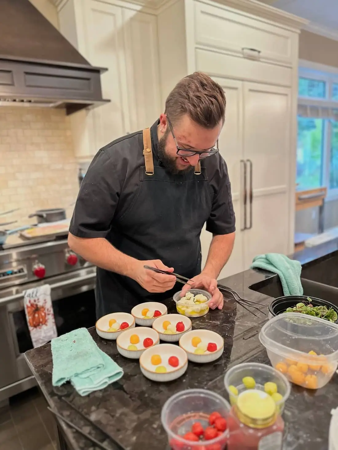Chef Josh plating a dish, hands at work in a home kitchen