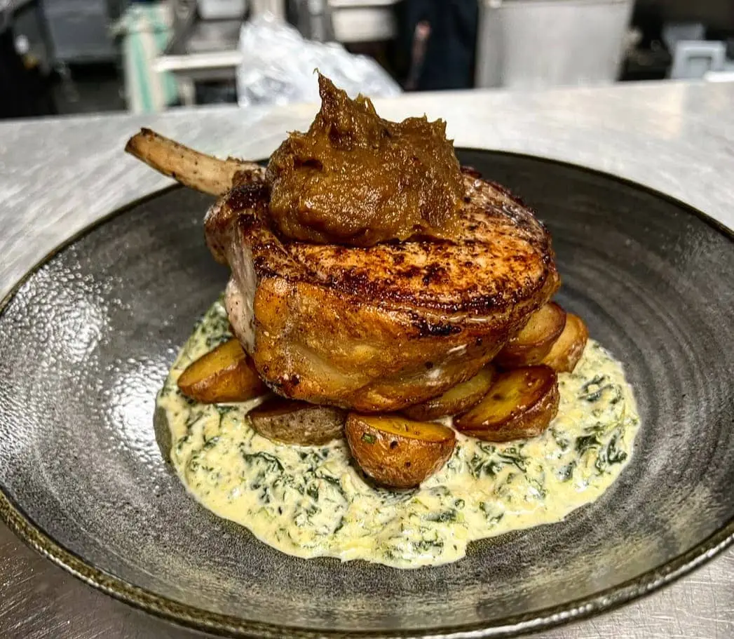Bone-in pork chop, creamed greens, roasted potato